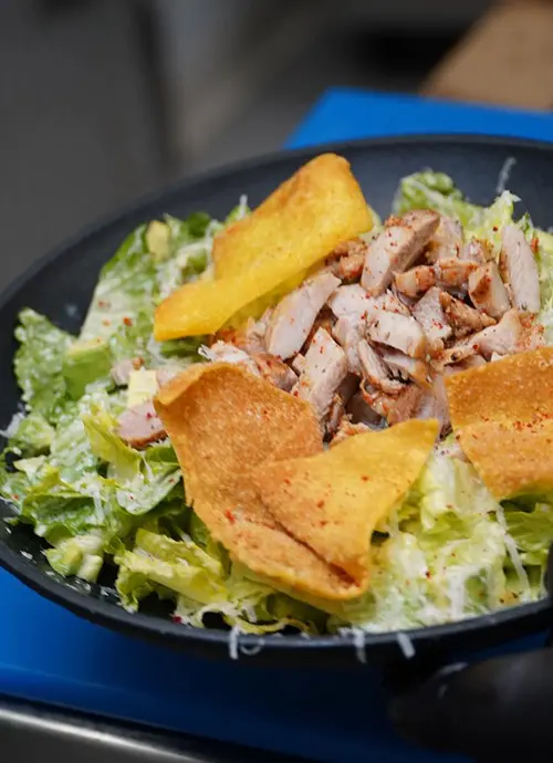 Chicken on top of salad